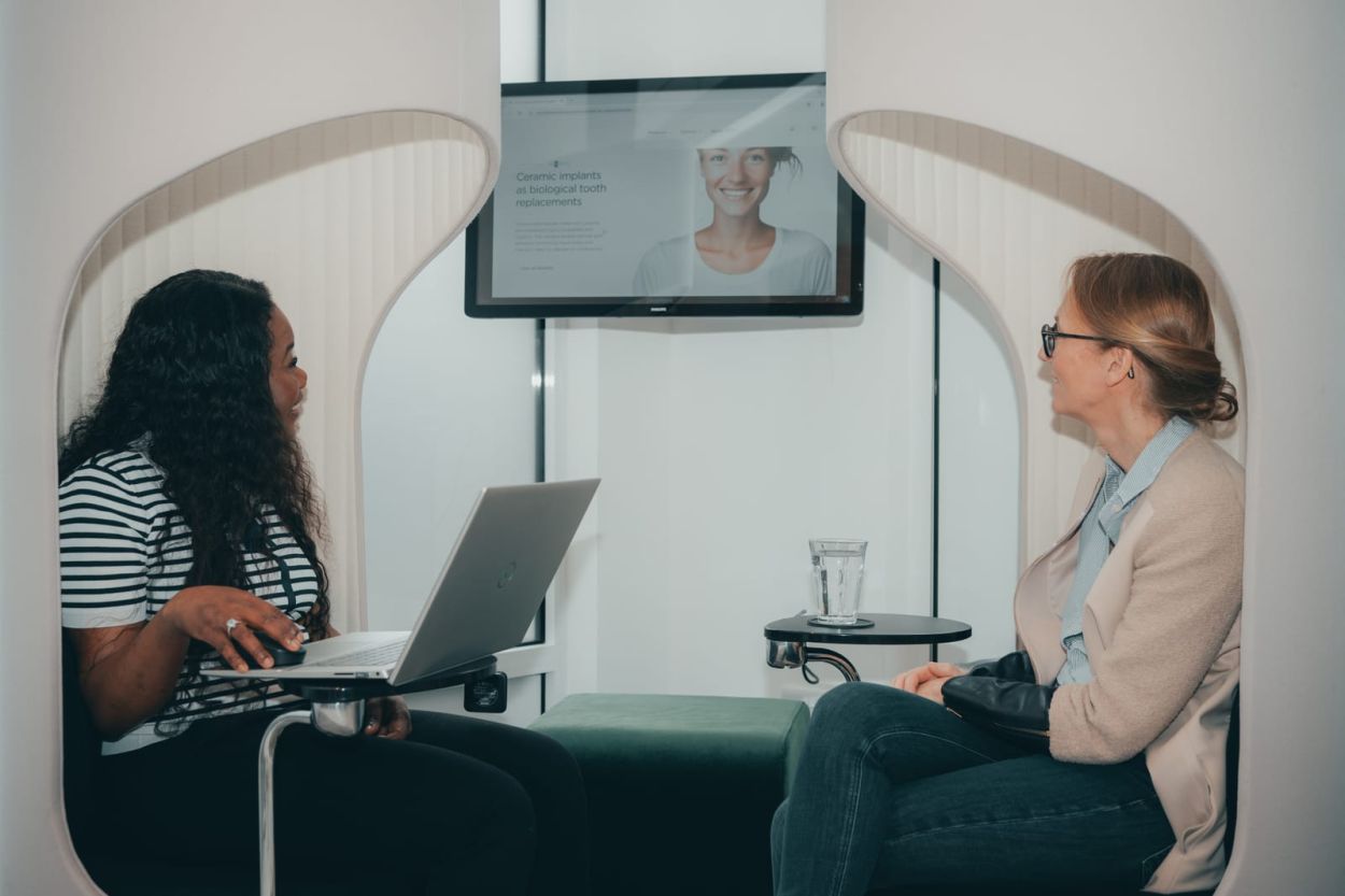 Patient liaison team member talking through implant options with a patient